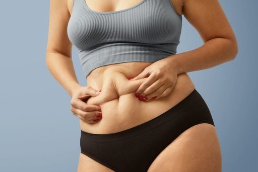 woman-body-fat-belly-obese-woman-hands-holding-exc