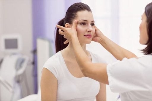 dermatologist-examining-female-patient-skin_107420